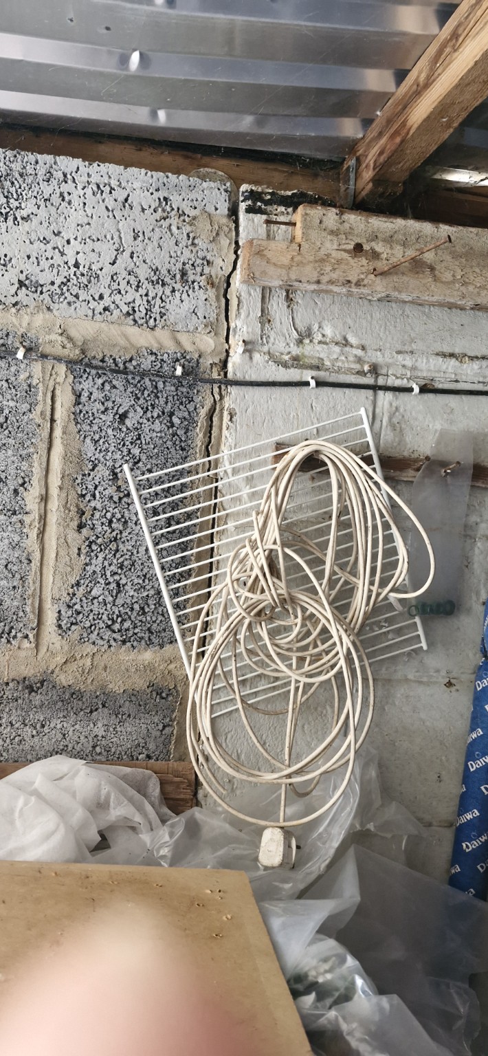 Crack in the garage's unfinished internal block wall before repair
